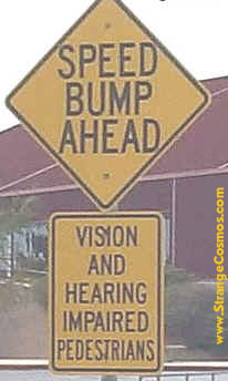Two signs posted together: (1) Speed bump ahead, (2) Vision and hearing impaired pedestrians