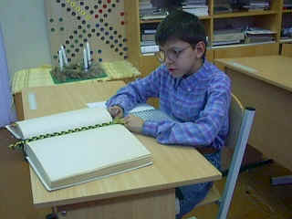 Boy sitting in front of a Brailled book